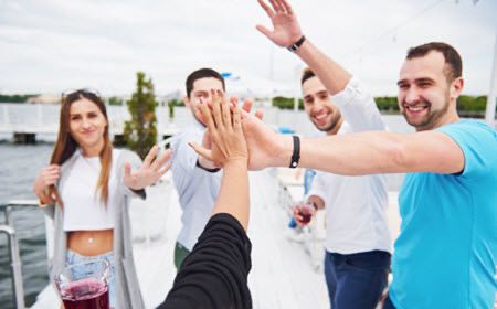 Friends celebrating a graduation on a Prince Charters dock