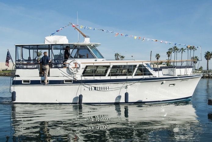Licensed coast guard captain driving luxury yacht in Huntington Harbour, CA